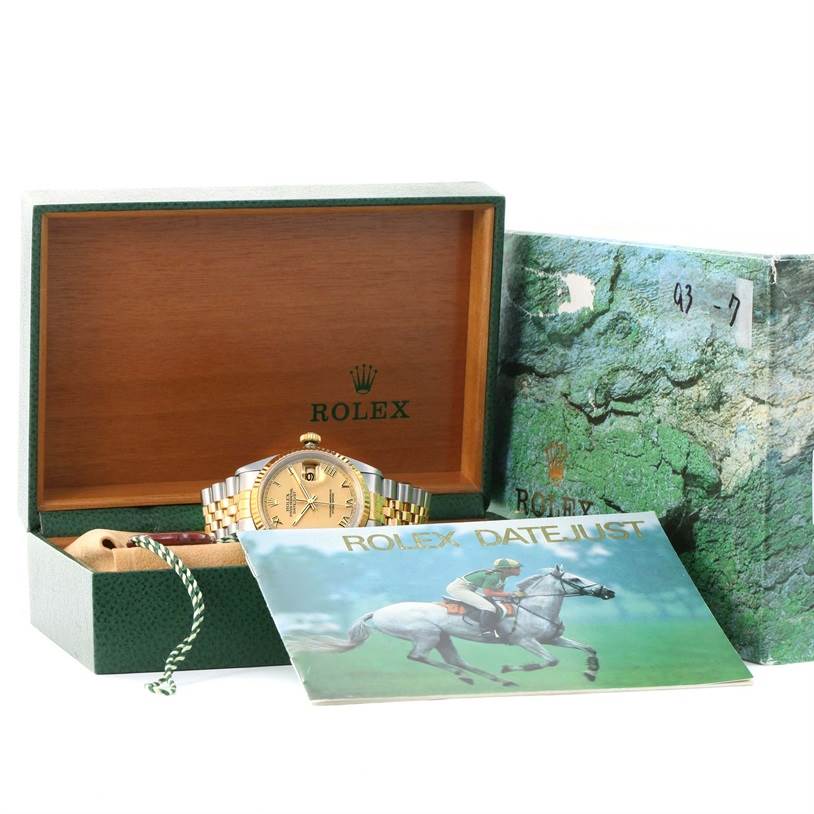 The image depicts a Rolex Datejust 16233 Men
s Steel and Gold (two tone) Champagne Dial 16233 Men
s Steel and Gold (two tone) Champagne Dial watch in its box with accompanying booklet and accessories, shown from a frontal angle.