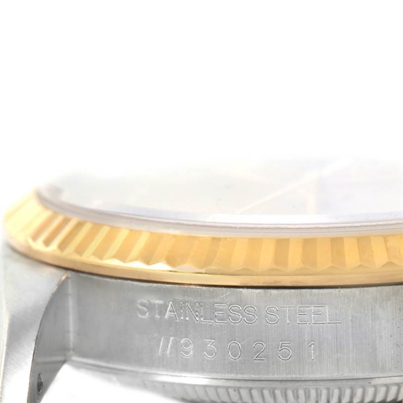 This image shows a close-up side view of the stainless steel case and fluted bezel of a Rolex Datejust 16233 Men
s Steel and Gold (two tone) Champagne Dial 16233 Men
s Steel and Gold (two tone) Champagne Dial watch.