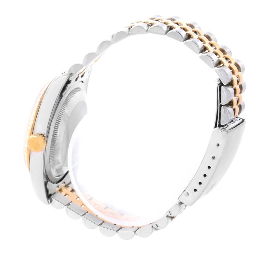 This image shows a side view of the Rolex Datejust 16233 Men
s Steel and Gold (two tone) Champagne Dial 16233 Men
s Steel and Gold (two tone) Champagne Dial watch, highlighting the gold crown, two-tone bracelet, and case.