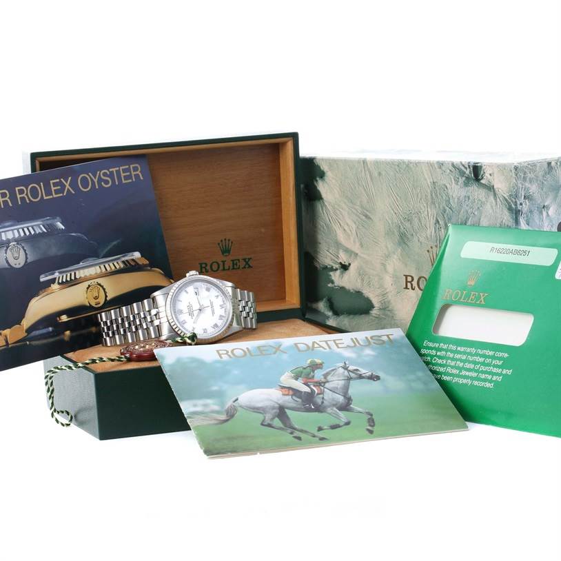 The image shows a Rolex Datejust 16220 Men's Stainless Steel White Dial 16220 Men's Stainless Steel White Dial watch with its box, warranty card, and booklets from a side angle.