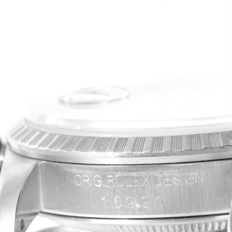 Close-up side view of a Rolex Datejust 16220 Men's Stainless Steel White Dial 16220 Men's Stainless Steel White Dial watch showing the bezel and engraved case with "ORIG ROLEX DESIGN" and "16220".