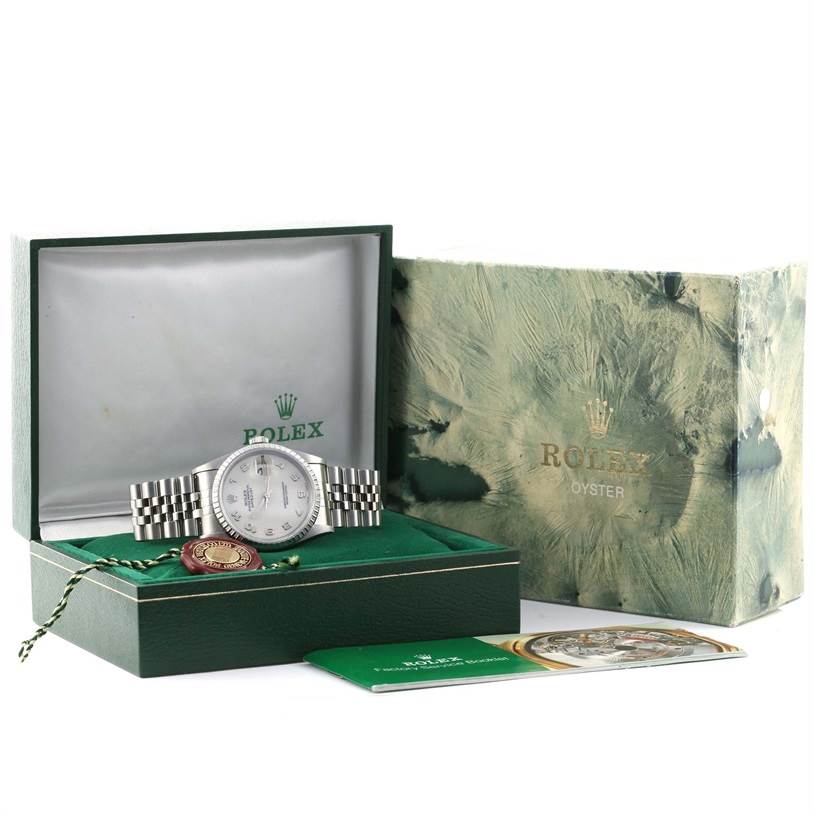 The image shows a Rolex Datejust 16220 Men's Stainless Steel Beige Dial 16220 Men's Stainless Steel Beige Dial watch at an angle inside its open box, with accessories like a booklet and a hang tag.