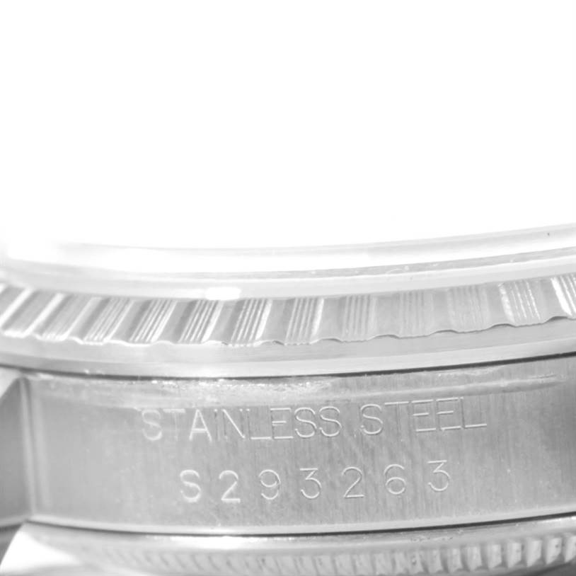 The image shows a close-up of the stainless steel case and bezel of a Rolex Datejust 16220 Men's Stainless Steel Beige Dial 16220 Men's Stainless Steel Beige Dial watch, highlighting its serial number.