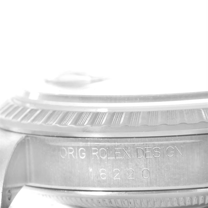 This image shows a close-up of the side engraving and bezel of a Rolex Datejust 16220 Men's Stainless Steel Beige Dial 16220 Men's Stainless Steel Beige Dial watch model 16220.