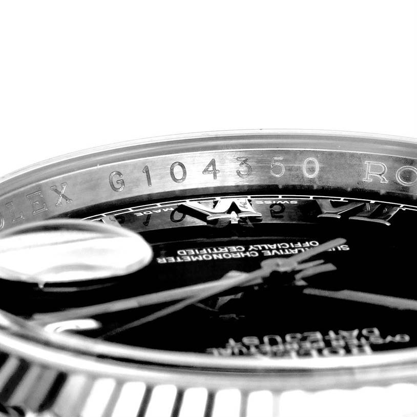 This image shows a close-up of the bezel and part of the dial of a Rolex Datejust 116234 Men
s Stainless Steel Black Dial 116234 Men
s Stainless Steel Black Dial watch, revealing the serial number.
