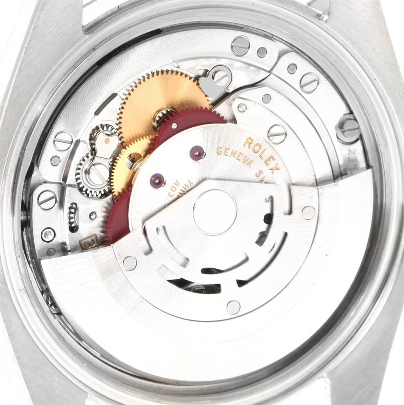 The image shows a close-up of the movement mechanism of a Rolex Datejust 116234 Men
s Stainless Steel Black Dial 116234 Men
s Stainless Steel Black Dial watch.