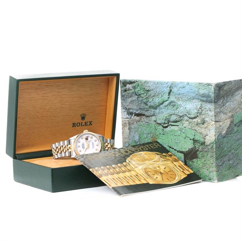 The image shows a Rolex Datejust 16233 Men's Steel and Gold (two tone) White Dial 16233 Men's Steel and Gold (two tone) White Dial watch at an angled view inside its open box, alongside the outer packaging and a booklet.