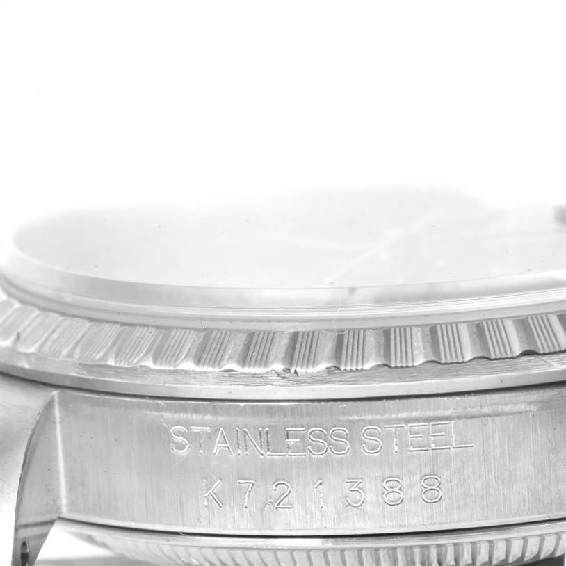 This image shows a close-up angle of a Rolex Datejust 16220 Men's Stainless Steel Blue Dial 16220 Men's Stainless Steel Blue Dial watch, highlighting its stainless steel case and part of the fluted bezel.