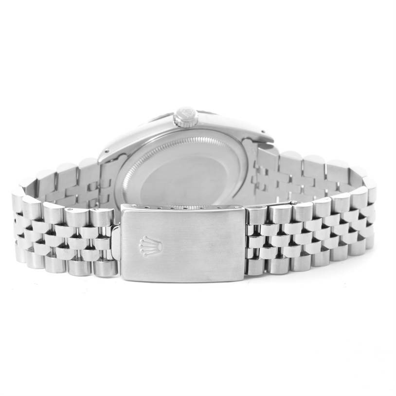 A rear view of a Rolex Datejust 16220 Men's Stainless Steel White Dial 16220 Men's Stainless Steel White Dial watch showing the bracelet and clasp with the engraved Rolex logo.