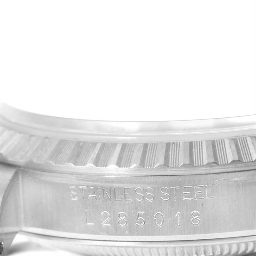 This image shows a close-up of the case and bezel of a Rolex Datejust 16220 Men's Stainless Steel White Dial 16220 Men's Stainless Steel White Dial model, including the engraved serial number.