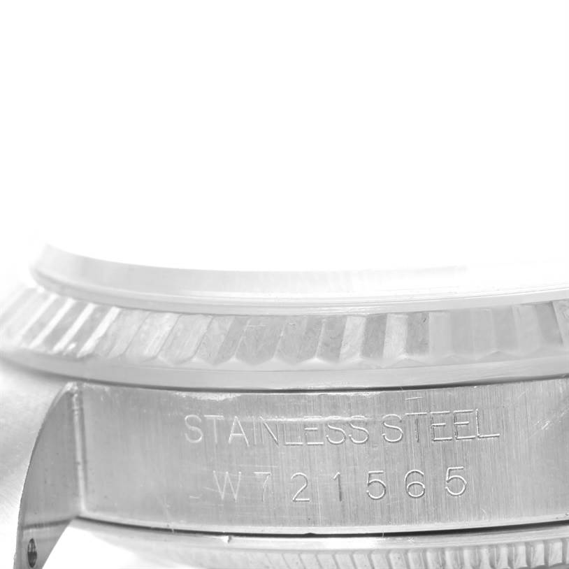 The image shows a close-up side view of the bezel and case of a Rolex Datejust 16234 Men's Stainless Steel White Dial 16234 Men's Stainless Steel White Dial watch, highlighting the fluted bezel and engraved serial number.