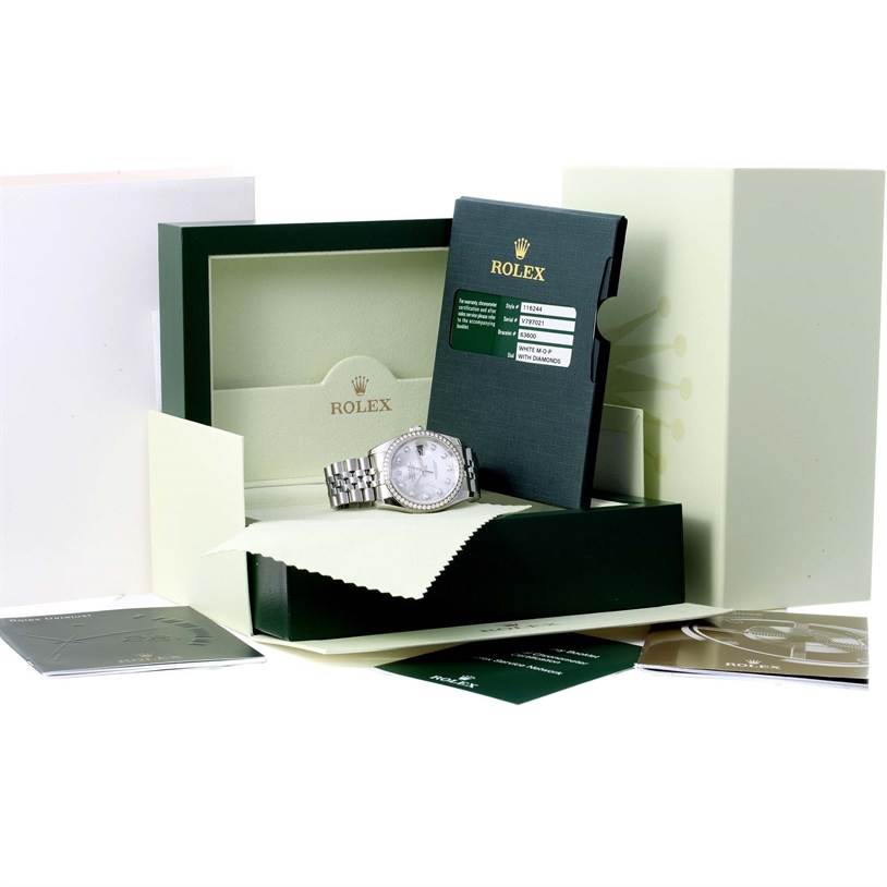 The image shows a Rolex Datejust 116244 Men's Stainless Steel Mother of Pearl Dial 116244 Men's Stainless Steel Mother of Pearl Dial watch and its accessories, including the box, documentation, and warranty card, from an angled view.