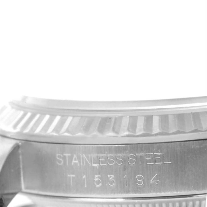 This image shows a close-up side view of the stainless steel casing and fluted bezel of a Rolex Datejust 16234 Men's Stainless Steel White Dial 16234 Men's Stainless Steel White Dial watch.