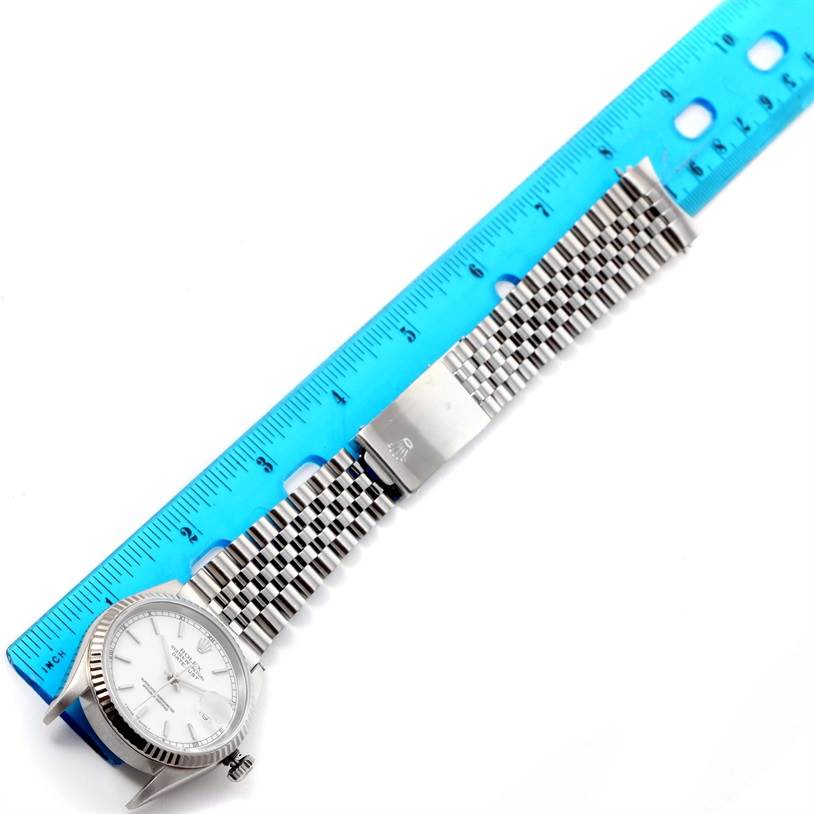 The image shows a Rolex Datejust 16234 Men's Stainless Steel White Dial 16234 Men's Stainless Steel White Dial watch lying flat with a blue ruler measuring its length.
