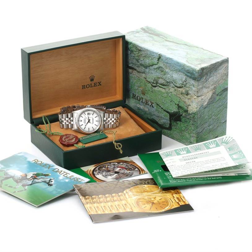 The image shows a Rolex Datejust 16234 Men's Stainless Steel White Dial 16234 Men's Stainless Steel White Dial watch, displayed in its open box with accompanying booklets and documents.