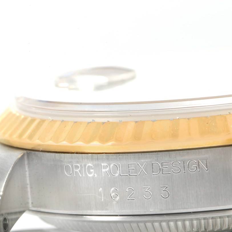 This image shows a close-up of the side view of a Rolex Datejust 16233 Men's Steel and Gold (two tone) Blue Dial 16233 Men's Steel and Gold (two tone) Blue Dial model, highlighting the bezel and case with the engraved model number 16233.