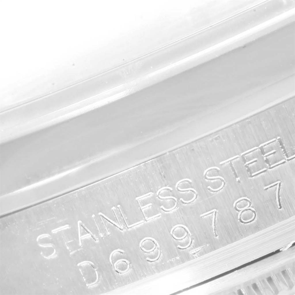 This close-up image shows the engraved serial number and material marking on the stainless steel case of a Rolex Datejust 116200 Men's Stainless Steel Blue Dial 116200 Men's Stainless Steel Blue Dial watch.