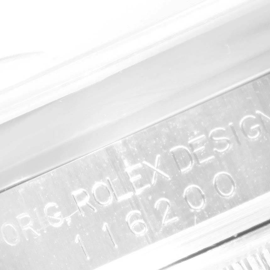 The image shows a close-up of the engraved model number "116200" and "Rolex Design" text on the case of a Rolex Datejust 116200 Men's Stainless Steel Blue Dial 116200 Men's Stainless Steel Blue Dial watch.