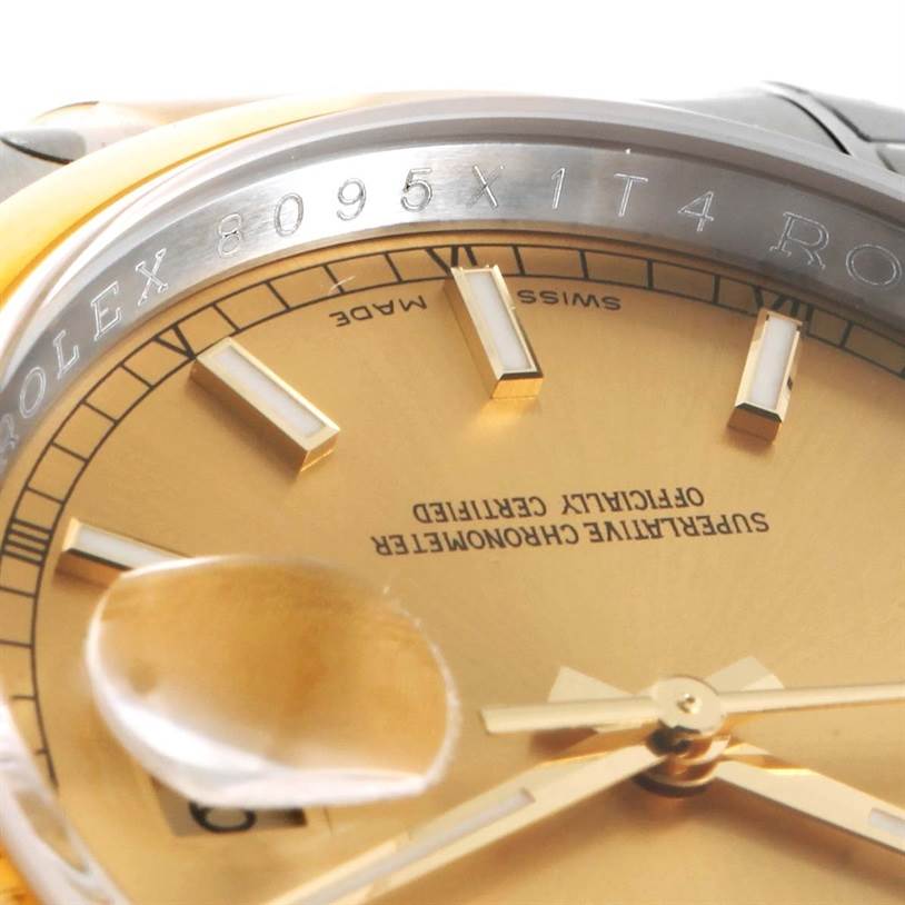 This close-up image of the Rolex Datejust 116203 Men's Stainless Steel Champagne Dial 116203 Men's Stainless Steel Champagne Dial watch shows the dial, hands, and part of the bezel with serial numbers.