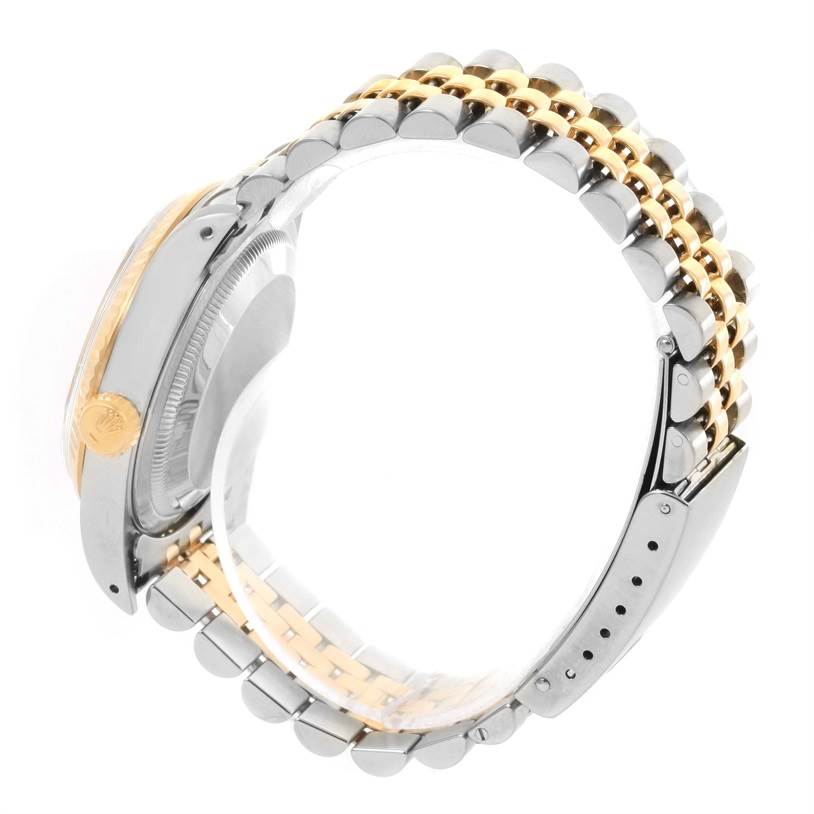 The image shows the side view of a Rolex Datejust 16233 Men's Steel and Gold (two tone) Beige Dial 16233 Men's Steel and Gold (two tone) Beige Dial's clasp and bracelet with gold and silver links.