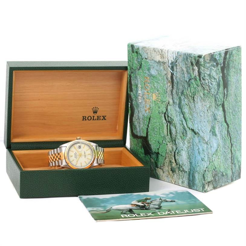 The Rolex Datejust 16233 Men's Steel and Gold (two tone) Beige Dial 16233 Men's Steel and Gold (two tone) Beige Dial watch is shown in its open green and wood box, alongside the outer box and an instruction booklet.