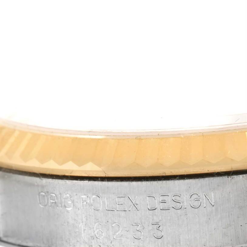 This close-up image shows the bezel and part of the case of a Rolex Datejust 16233 Steel and Gold (two tone) Champagne Dial 16233 Steel and Gold (two tone) Champagne Dial watch with visible model number engraving.