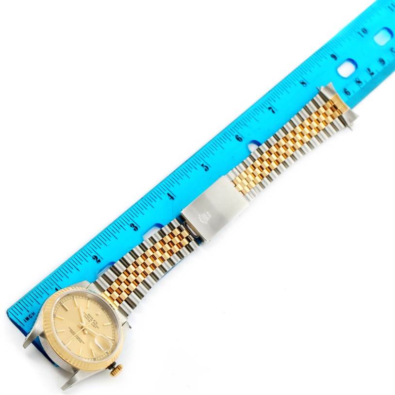 The Rolex Datejust 16233 Steel and Gold (two tone) Champagne Dial 16233 Steel and Gold (two tone) Champagne Dial watch is shown from a top-down angle, featuring the dial, bezel, and two-tone Jubilee bracelet with a clasp.