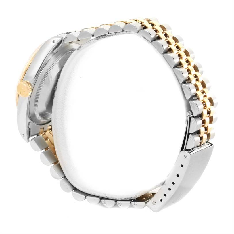 The image shows a side view of the Rolex Datejust 16233 Steel and Gold (two tone) Champagne Dial 16233 Steel and Gold (two tone) Champagne Dial model, highlighting its two-tone bracelet and the side profile of the watch case.