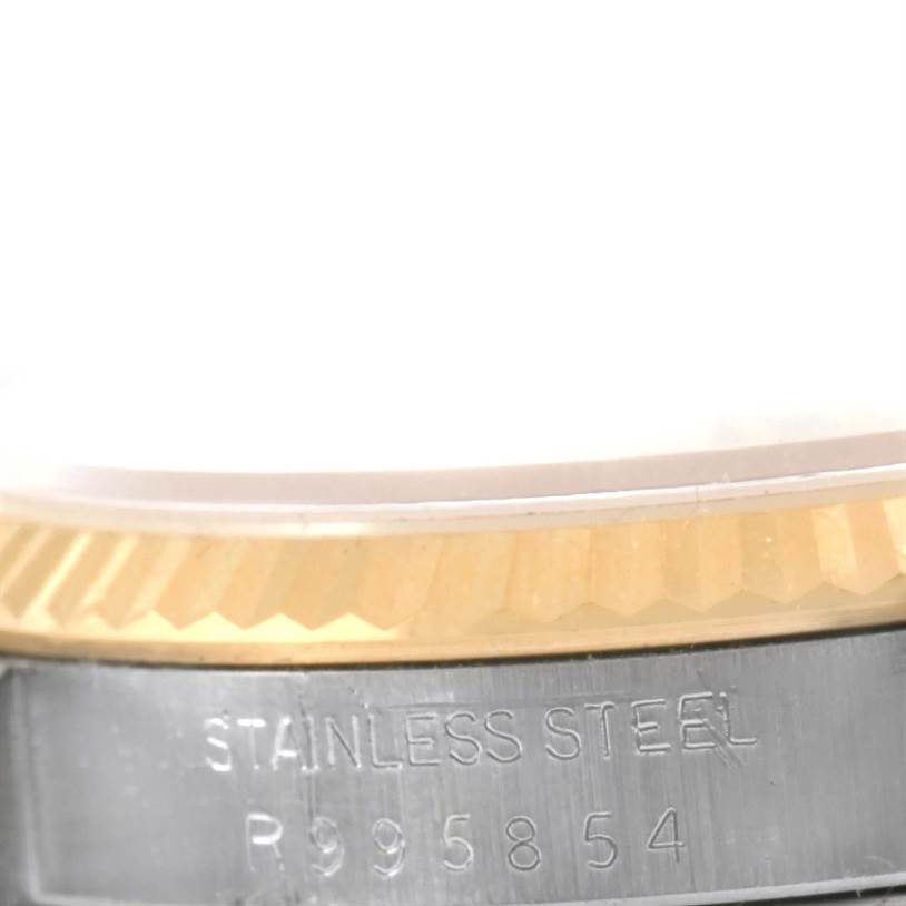 The image shows a close-up of the side view of a Rolex Datejust 16233 Steel and Gold (two tone) Champagne Dial 16233 Steel and Gold (two tone) Champagne Dial watch, highlighting the fluted bezel and stainless steel case.