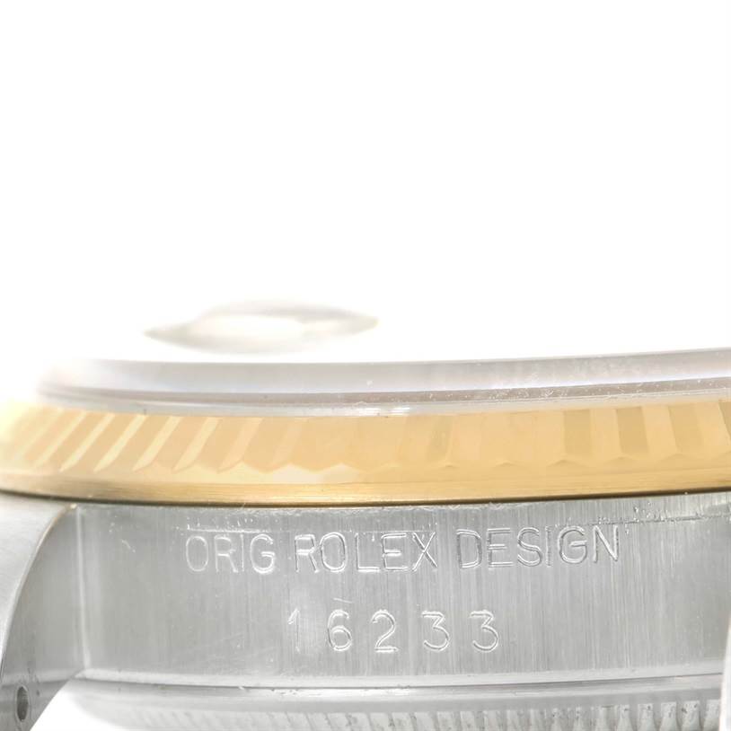 The image shows a side view of the bezel and case, displaying the "ORIG ROLEX DESIGN 16233" engraving on the Rolex Datejust 16233 Men's Steel and Gold (two tone) Beige Dial 16233 Men's Steel and Gold (two tone) Beige Dial watch.