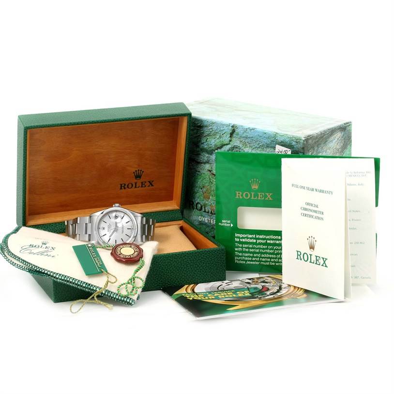 The image shows a Rolex Datejust 16200 Men
s Stainless Steel Silver Dial 16200 Men
s Stainless Steel Silver Dial watch, its opened box, booklets, tag, and warranty card.