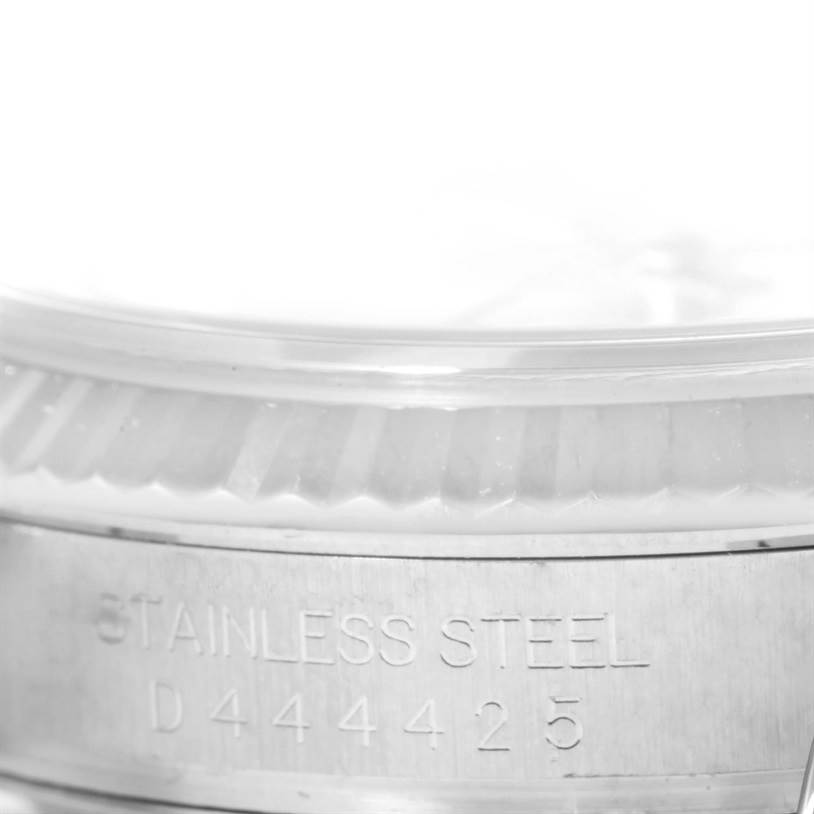 This image shows a close-up of the stainless steel case and part of the fluted bezel of a Rolex Datejust 116234 Men's Stainless Steel Silver Dial 116234 Men's Stainless Steel Silver Dial watch.