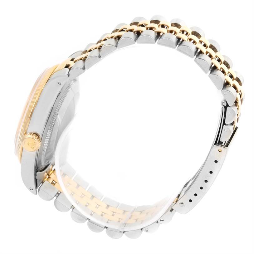 The image shows a side view of a Rolex Datejust 16233 Men's Steel and Gold (two tone) White Dial 16233 Men's Steel and Gold (two tone) White Dial watch, highlighting its crown, case, and two-tone bracelet.