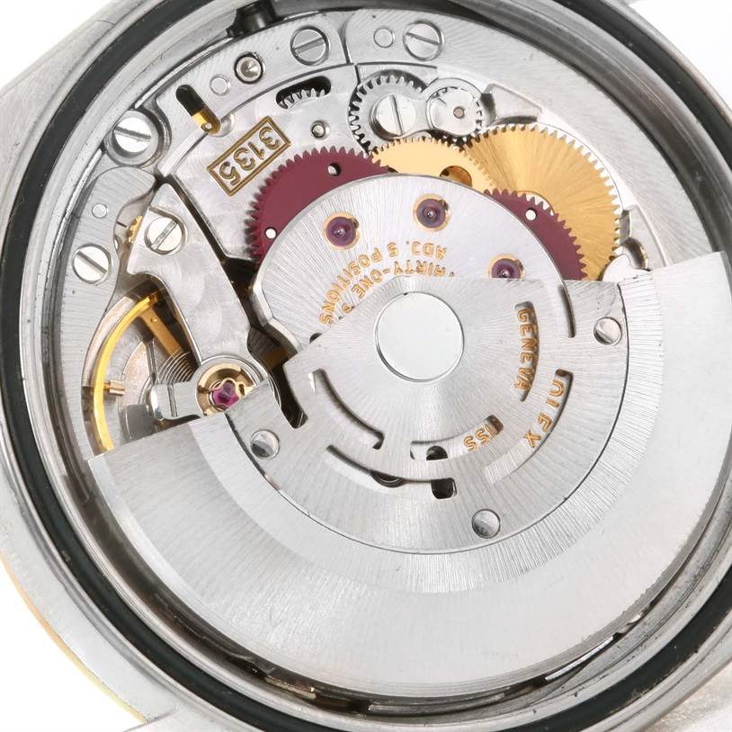 This image shows the Rolex Datejust 16233 Men's Steel and Gold (two tone) White Dial 16233 Men's Steel and Gold (two tone) White Dial watch movement from a top-down angle, revealing the internal gears and rotor.