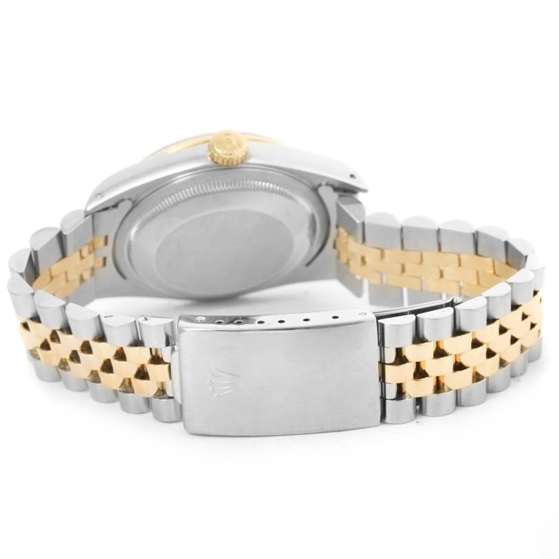 This image shows the back case, crown, and two-tone bracelet of a Rolex Datejust 16233 Men's Steel and Gold (two tone) White Dial 16233 Men's Steel and Gold (two tone) White Dial watch.