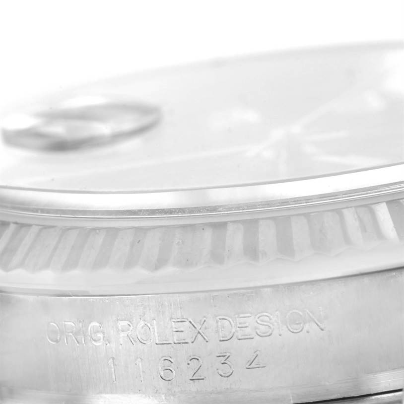 The image shows a close-up side view of the bezel and serial number engraving on a Rolex Datejust 116234 Men's Stainless Steel Blue Dial 116234 Men's Stainless Steel Blue Dial watch.