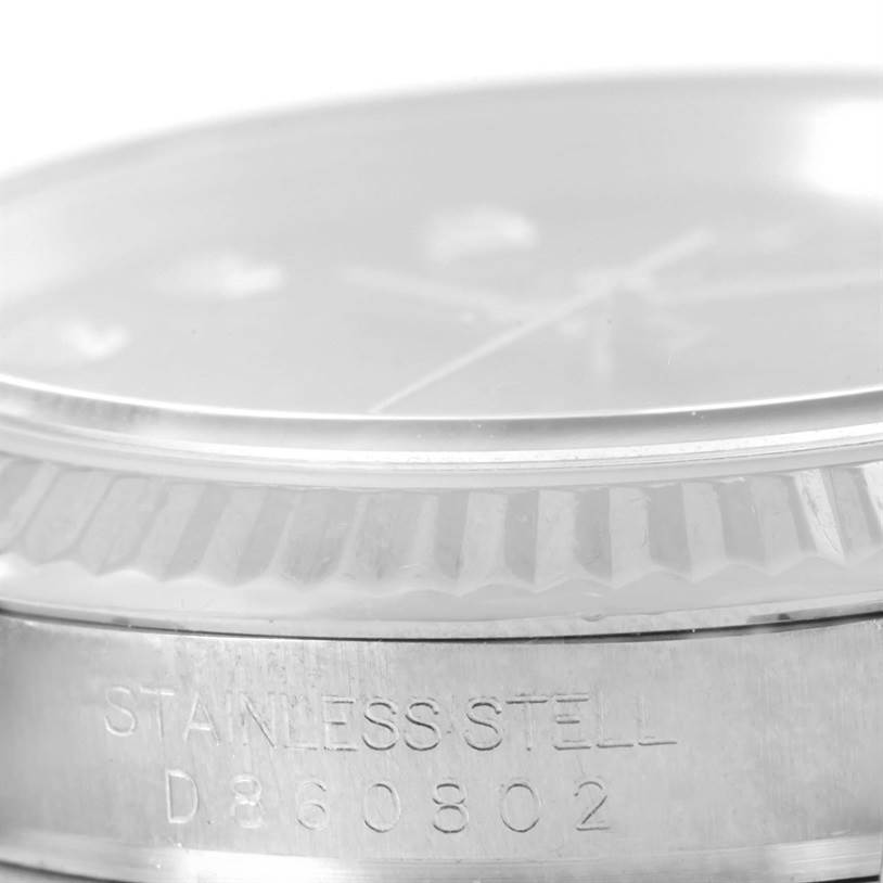 The image shows a low-angle close-up of the bezel, crystal, and part of the case of a Rolex Datejust 116234 Men's Stainless Steel Blue Dial 116234 Men's Stainless Steel Blue Dial watch.