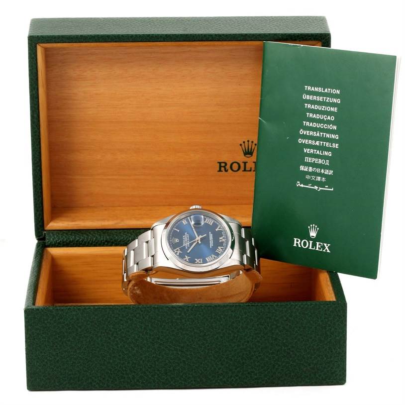 The image shows a Rolex Datejust 16200 Men's Stainless Steel Blue Dial 16200 Men's Stainless Steel Blue Dial watch positioned frontally in an open green box with its manual beside it.