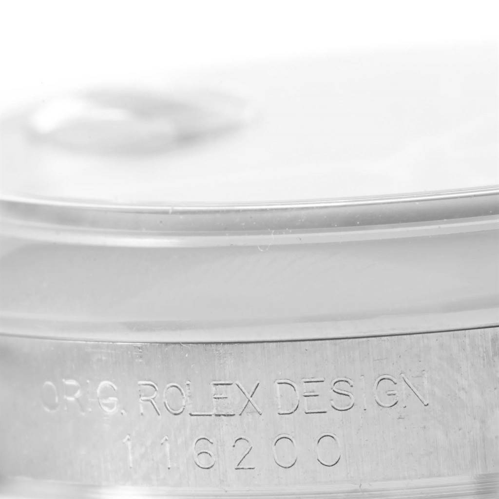 This image shows an angled close-up of the Rolex Datejust 116200 Men's Stainless Steel Black Dial 116200 Men's Stainless Steel Black Dial case back, featuring the "ROLEX DESIGN" engraving and model number 116200.