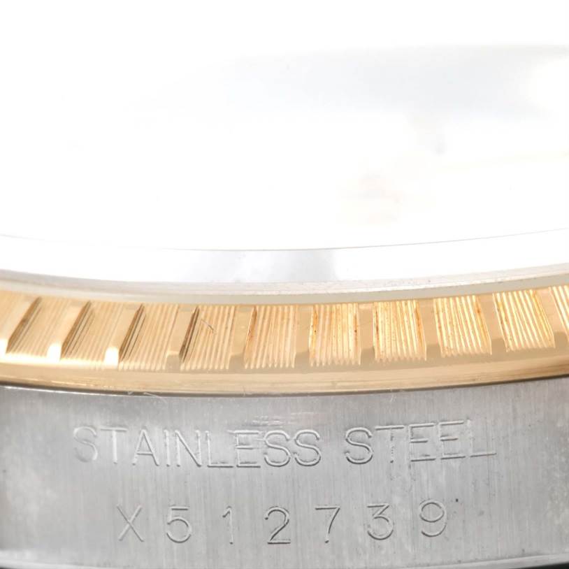 The image shows a close-up view of the serial number and grooved edge on the bezel of the Rolex Datejust 15223 Men's Steel and Gold (two tone) White Dial 15223 Men's Steel and Gold (two tone) White Dial watch.