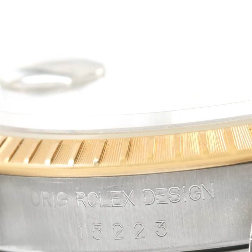 The image shows a close-up of the bezel, case, and engraved serial number of a Rolex Datejust 15223 Men's Steel and Gold (two tone) White Dial 15223 Men's Steel and Gold (two tone) White Dial watch.