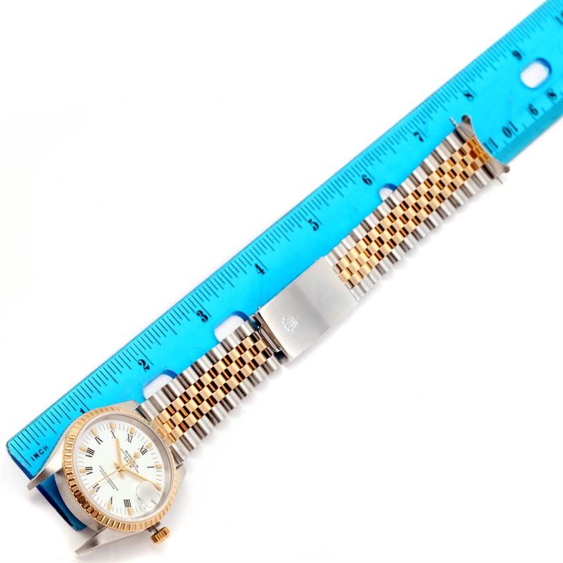 The image shows a Rolex Datejust 15223 Men's Steel and Gold (two tone) White Dial 15223 Men's Steel and Gold (two tone) White Dial watch with a jubilee bracelet and clasp, laid flat alongside a measuring ruler.