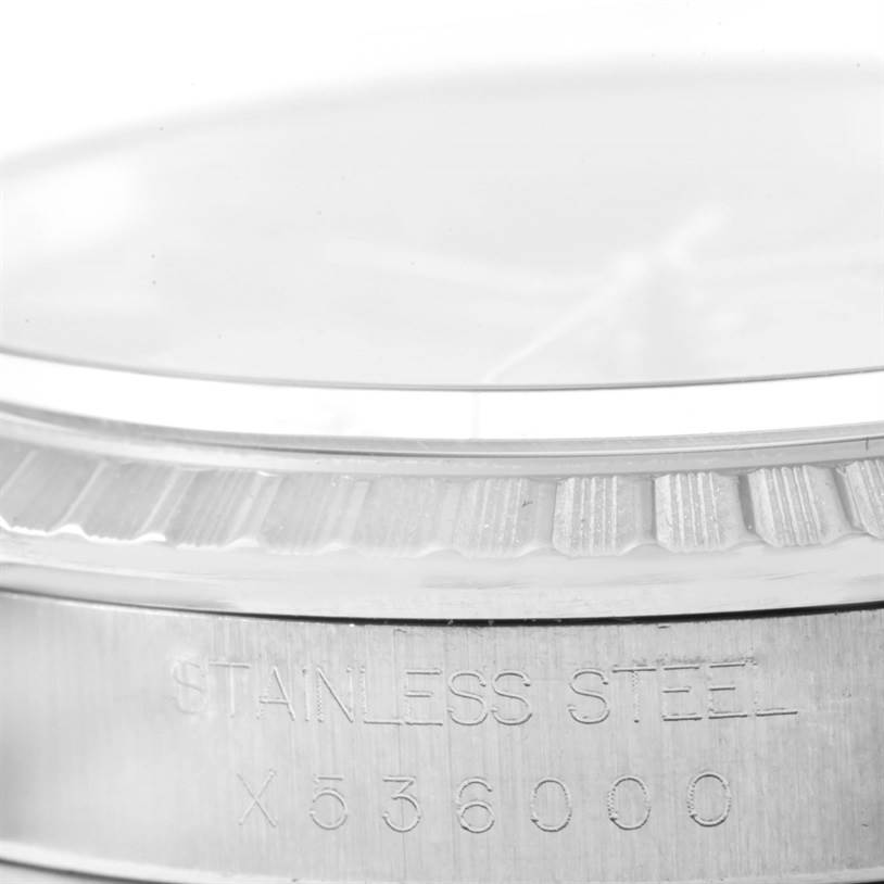 This close-up image shows the side of the stainless steel bezel of a Rolex Datejust 16220 Men
s Stainless Steel Black Dial 16220 Men
s Stainless Steel Black Dial watch.