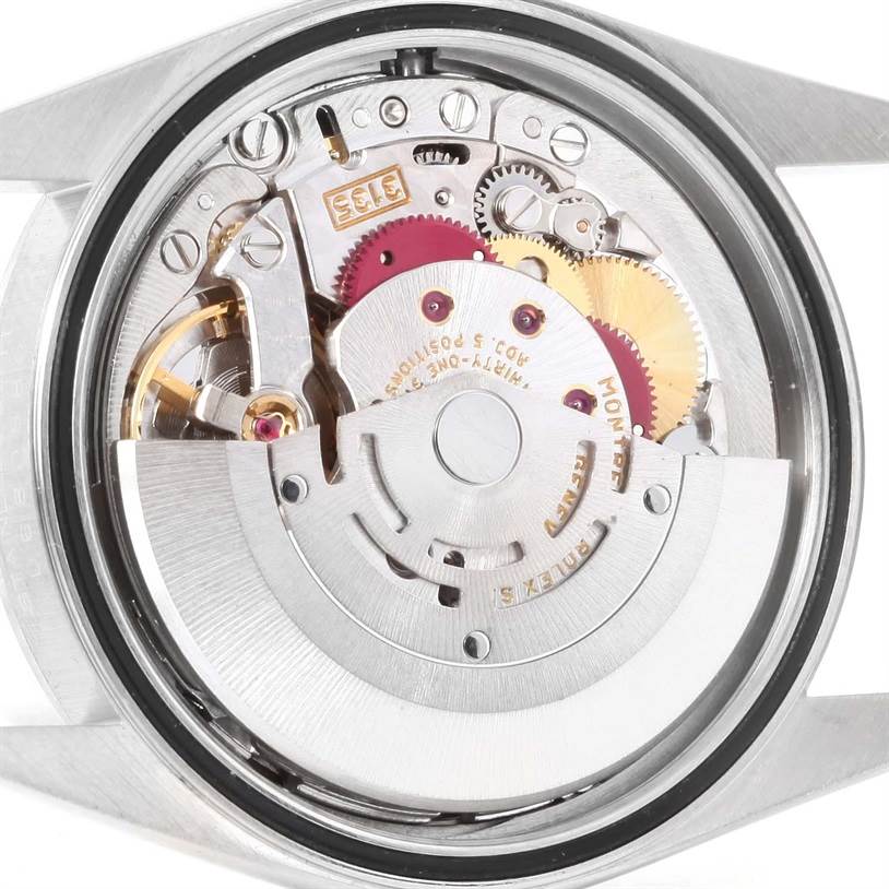 The image shows a close-up of the movement inside the Rolex Datejust 16200 Men
s Stainless Steel White Dial 16200 Men
s Stainless Steel White Dial watch, highlighting gears and mechanical parts.