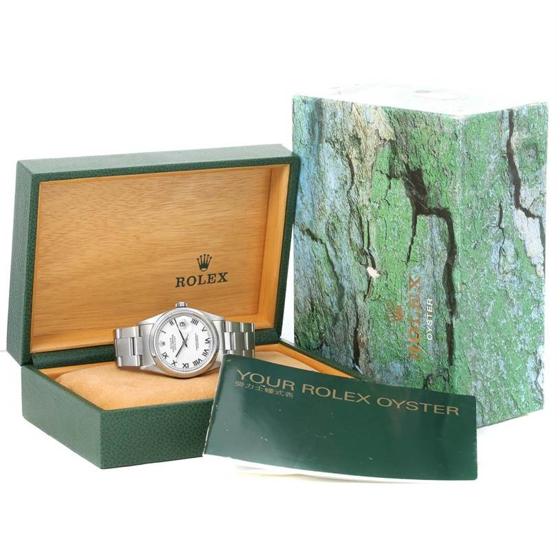 This image shows a Rolex Datejust 16200 Men
s Stainless Steel White Dial 16200 Men
s Stainless Steel White Dial watch in an open green and wooden box, alongside its packaging and booklet.