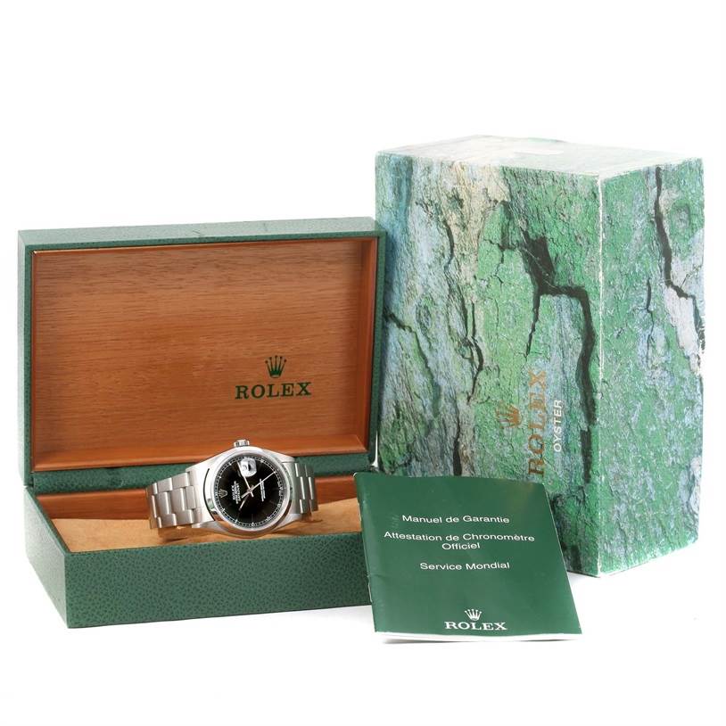 This image shows a Rolex Datejust 16200 Men
s Stainless Steel Black Dial 16200 Men
s Stainless Steel Black Dial watch in its open box, accompanied by its packaging and manuals.