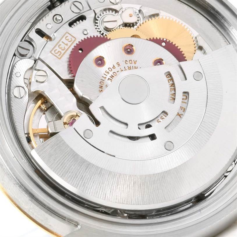 The image shows the movement and internal mechanism of a Rolex Datejust 116233 Men's Stainless Steel Champagne Dial 116233 Men's Stainless Steel Champagne Dial watch from a close-up angle.