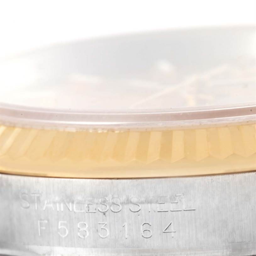 This image shows a close-up of the bezel and serial number on the stainless steel case of a Rolex Datejust 116233 Men's Stainless Steel Champagne Dial 116233 Men's Stainless Steel Champagne Dial watch.