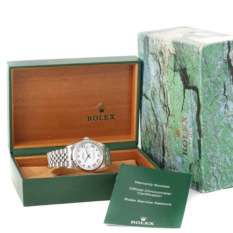 This image shows a Rolex Datejust 16234 Men
s Stainless Steel White Dial 16234 Men
s Stainless Steel White Dial watch in its open box along with its warranty booklet and outer box.