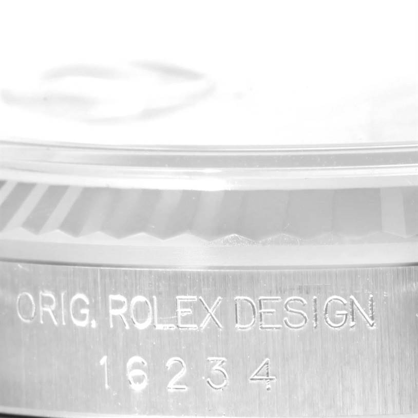 This close-up image shows the side of a Rolex Datejust 16234 Men
s Stainless Steel White Dial 16234 Men
s Stainless Steel White Dial watch, highlighting the model designation and part of the bezel.